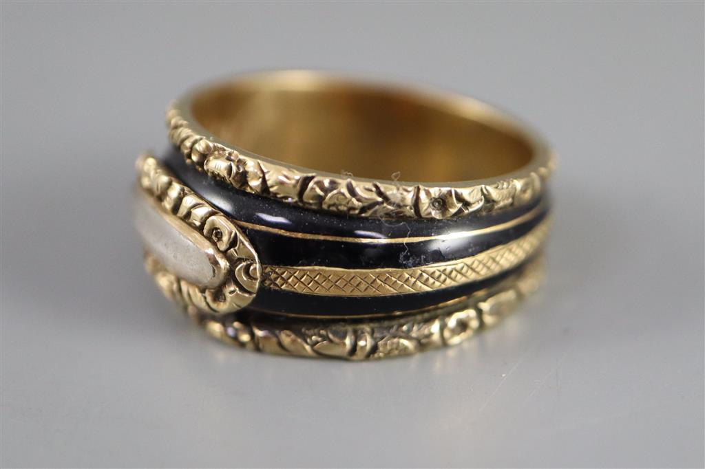 A George III gold and black enamel memorial ring with hairwork panel and a matching brooch,